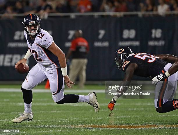 Paxton Lynch of the Denver Broncos breaks away from Christian Jones of the Chicago Bears at Soldier Field on August 11, 2016 in Chicago, Illinois....
