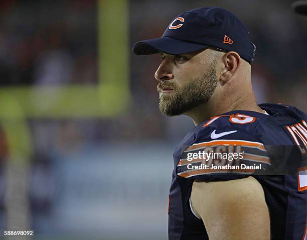 Kyle Long of the Chicago Bearswatches from the sidelines as teammates take on the Denver Broncos at Soldier Field on August 11, 2016 in Chicago,...