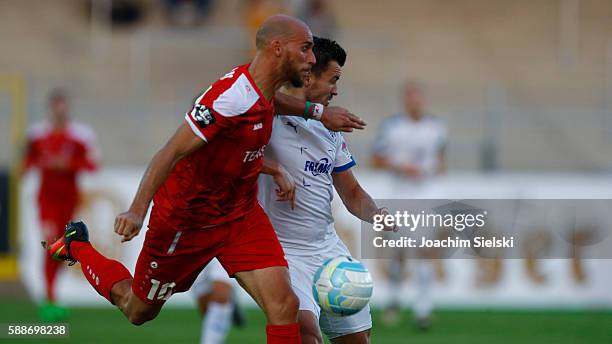Bernd Rosinger of Lotte challenges Daniel Brueckner of Erfurt during the third league match between SF Lotte and Rot-Weiss Erfurt at Frimo Stadion on...