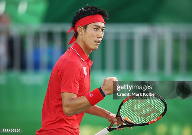 Kei Nishikori of Japan celebrates winning the first set against Gael Monfils of France in the Men's Singles Quarterfinal on Day 7 of the Rio 2016...