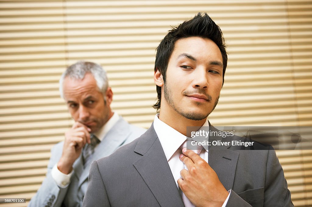 Businessman adjusting his necktie