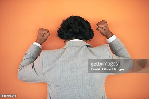 angry businessman hitting wall - oliver eltinger stock-fotos und bilder