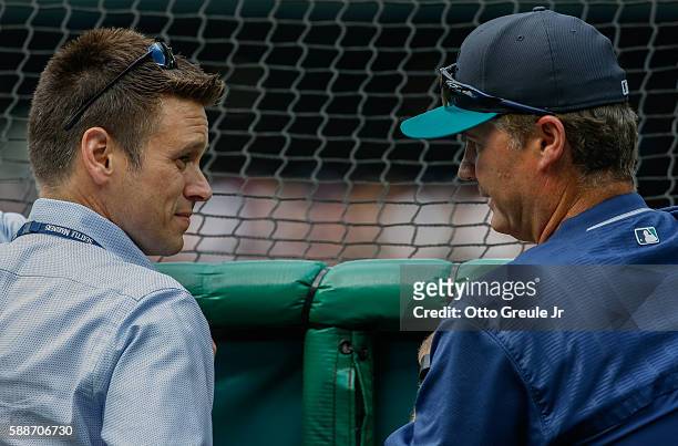 Jerry Dipoto and manager Scott Servais of the Seattle Mariners talk behind the batting cage prior to the game against the Boston Red Sox at Safeco...