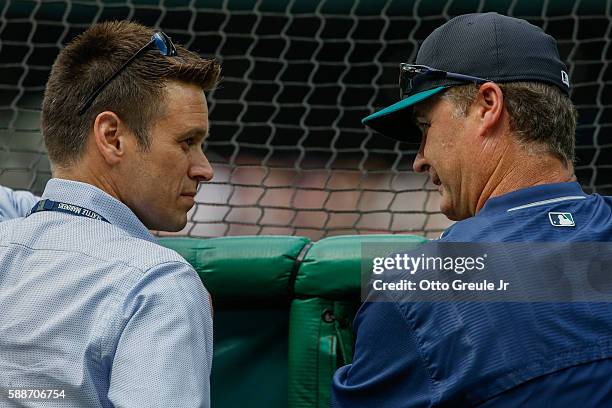 Jerry Dipoto and manager Scott Servais of the Seattle Mariners talk behind the batting cage prior to the game against the Boston Red Sox at Safeco...