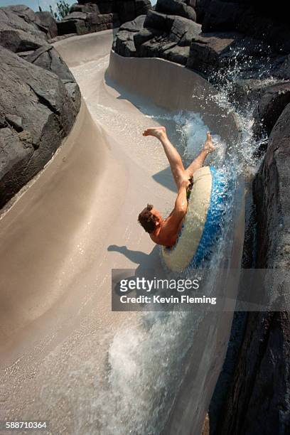 man riding water slide at disney world - typhoon lagoon stock pictures, royalty-free photos & images