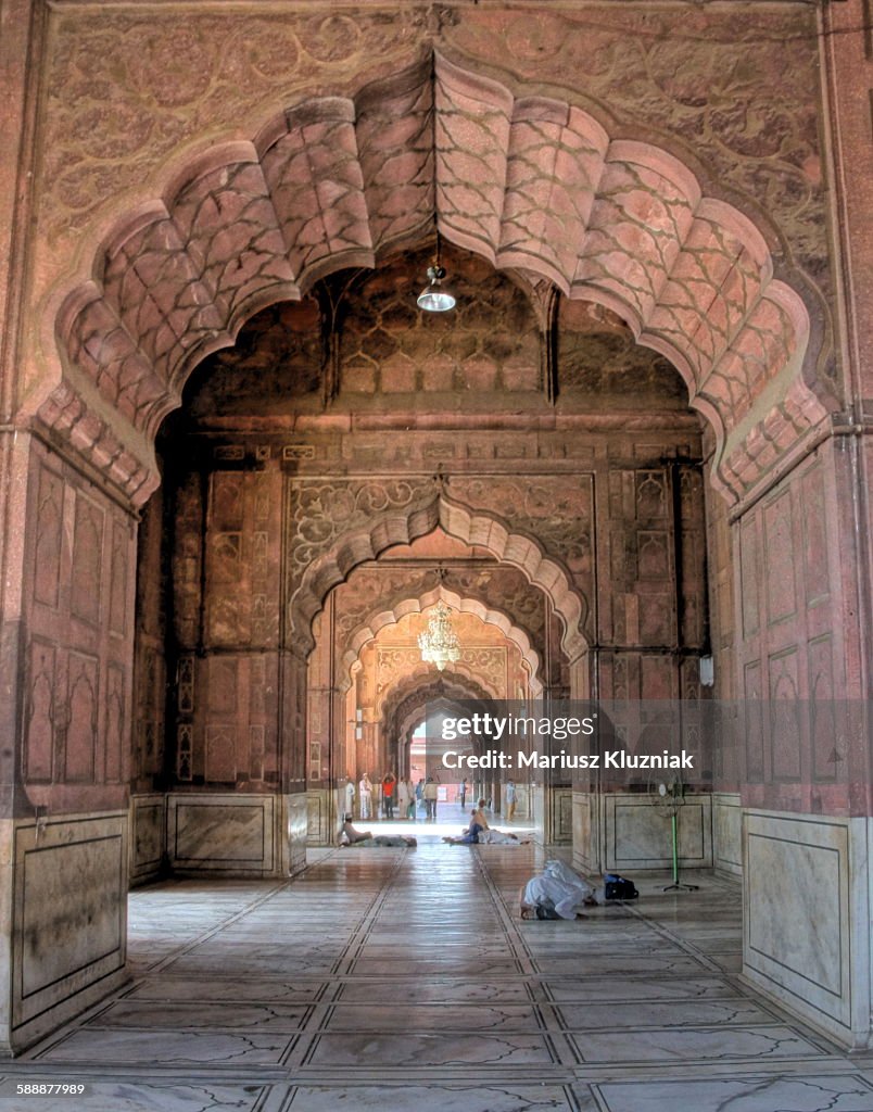 Jama Masjid mosque arches and praying men