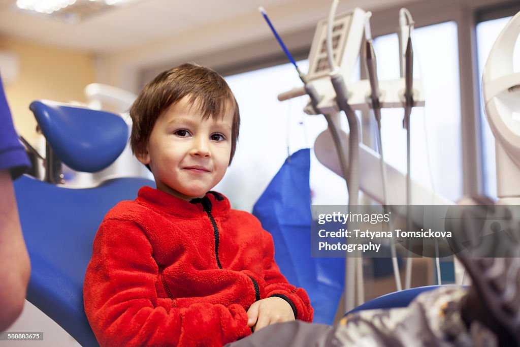 Little child, boy, sitting on a dentist chair