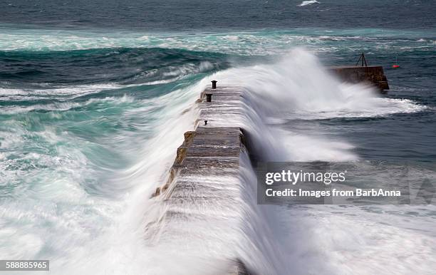 stormy weather at sennen cove, cornwall, england - groyne stock-fotos und bilder