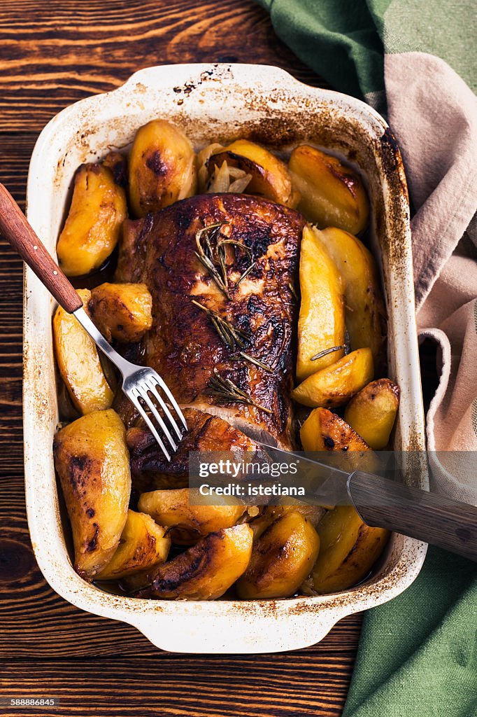 Roasted pork loin with  potatoes in roasting pan