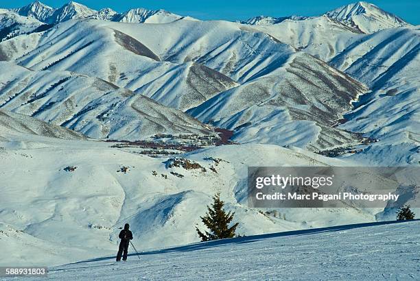 a skier skis in the sawtooth mountain range - ketchum idaho stock pictures, royalty-free photos & images