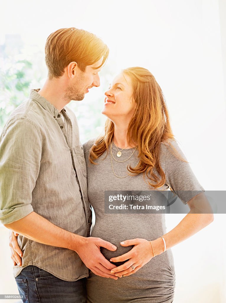 Mid-adult couple face to face outdoors