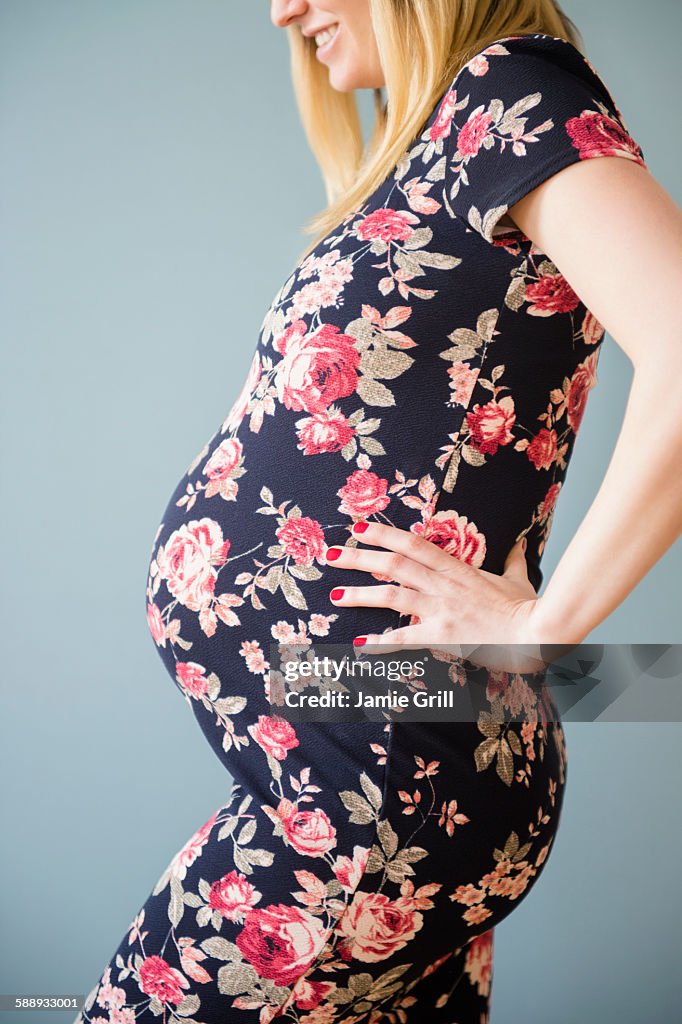 Studio shot of pregnant woman in floral dress