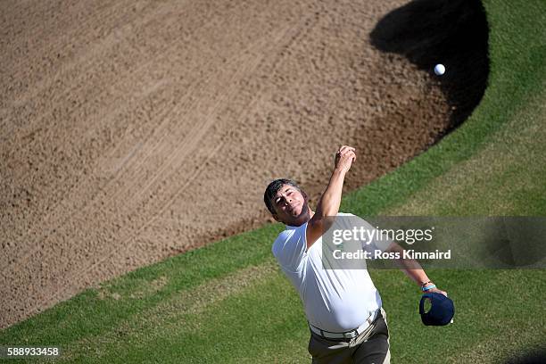 Adilson da Silva of Brazil throws his ball into the crowd on the 18th green during the second round of the Olympic Golf on Day 7 of the Rio 2016...