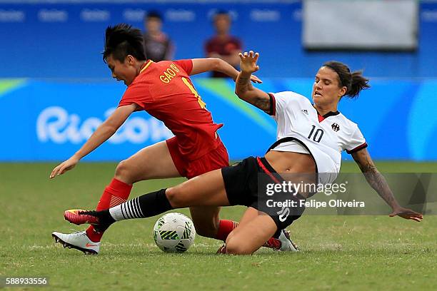 Dzsenifer Marozsan of Germany tackles Chen Gao of China during the Women's Football Quarterfinal match between China and Germany on Day 7 of the Rio...