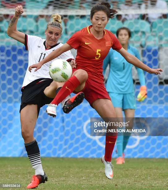Germany's forward Anja Mittag vies for the ball with China's defender Haiyan Wu during their Rio 2016 Olympic Games womens quarter final football...