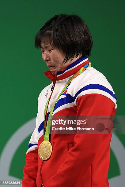 Gold medalist Jong Sim Rim of North Korea cries on the podium during the medal ceremony for the Weightlifting - Women's 75kg on Day 7 of the Rio 2016...