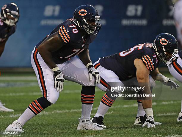 Bobby Massie of and Kyle Long of the Chicago Bears await the snap against the Denver Broncos at Soldier Field on August 11, 2016 in Chicago, Illinois.