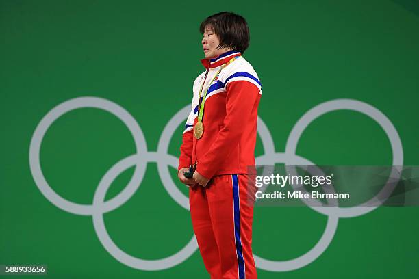 Gold medalist Jong Sim Rim of North Korea cries on the podium during the medal ceremony for the Weightlifting - Women's 75kg on Day 7 of the Rio 2016...