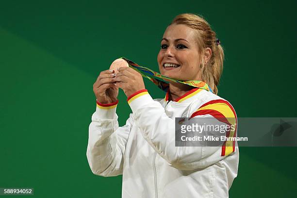 Bronze medalist Lidia Valentin Perez of Spain celebrates on the podium during the medal ceremony for the Weightlifting - Women's 75kg on Day 7 of the...