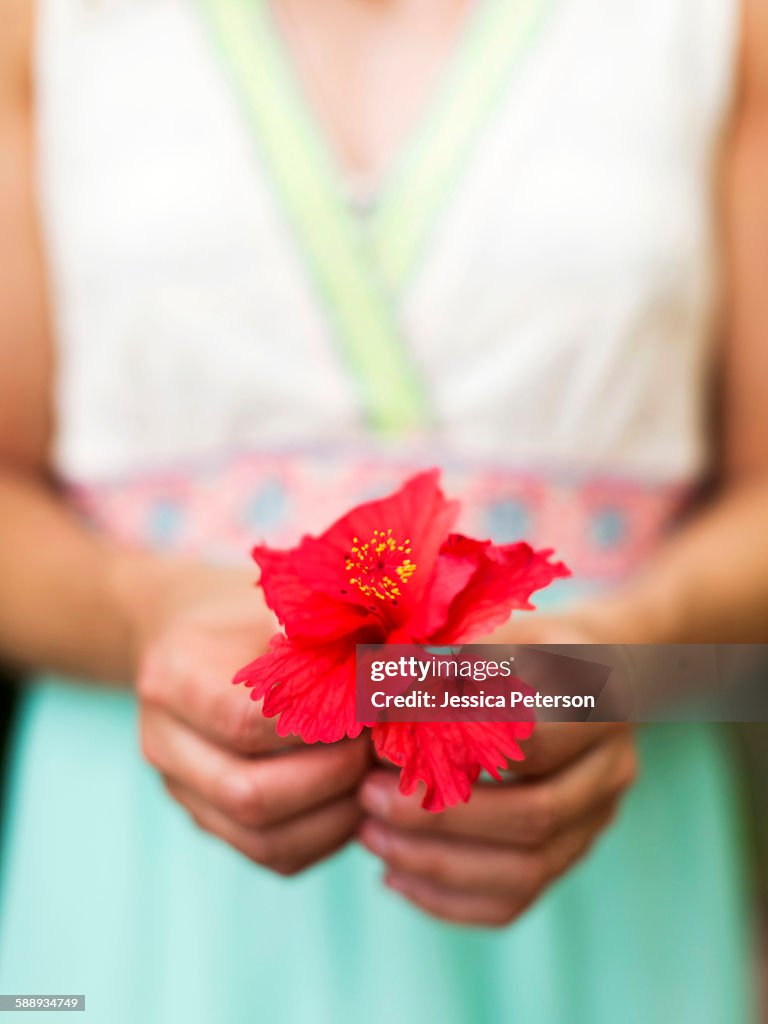 Woman holding tropical flower