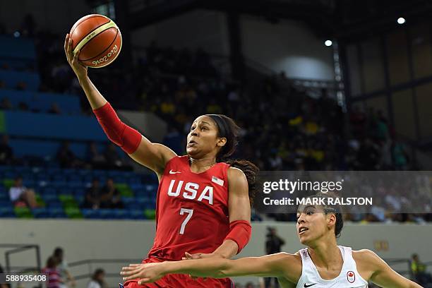 S forward Maya Moore goes to the basket ahead of Canada's guard Kia Nurse during a Women's round Group B basketball match between Canada and USA at...