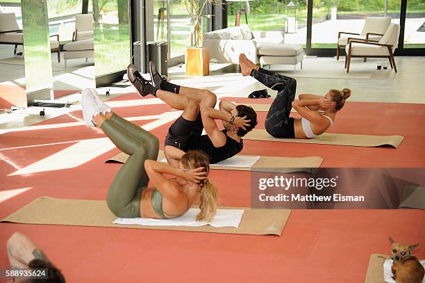 Jenne Lombardo, Akin Akman, and Nina Agdal work out at the Buick celebration of the new Envision in the Hamptons at Buick Studio Envision on August...