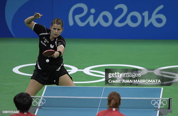 Germany's Petrissa Solja hits a shot in the women's team qualification round table tennis match against USA's Wu Yue and USA's Zheng Jiaqi at the...