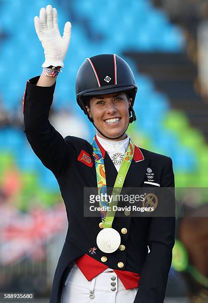 Charlotte Dujardin of Great Britain who won a team silver celebrates during the final day of the Dressage Grand Prix event on Day 7 of the Rio 2016...