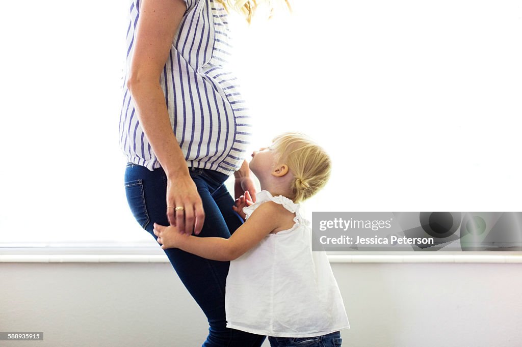 Daughter (2-3) with pregnant mother