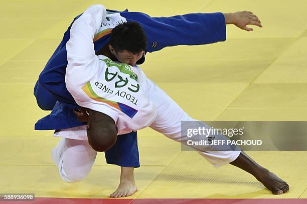 France's Teddy Riner fights with Japan's Hisayoshi Harasawa during the men's judo +100kg final gold medal contest at the Rio 2016 Olympic Games in...