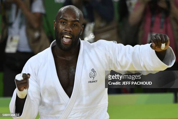 France's Teddy Riner celebrates after defeating Japan's Hisayoshi Harasawa during the men's judo +100kg final gold medal contest at the Rio 2016...