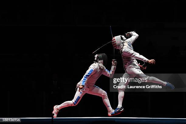 Andrea Baldini of Italy competes against Gerek Meinhardt of the United States during the Men's Foil Team Bronze Medal Match bout on Day 7 of the Rio...