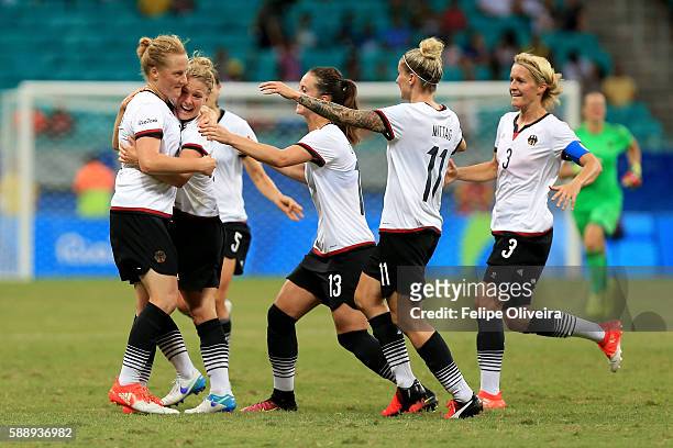 Melanie Behringer of Germany celebrates with team mates after scoring the opening goal during the Women's Football Quarterfinal match between China...