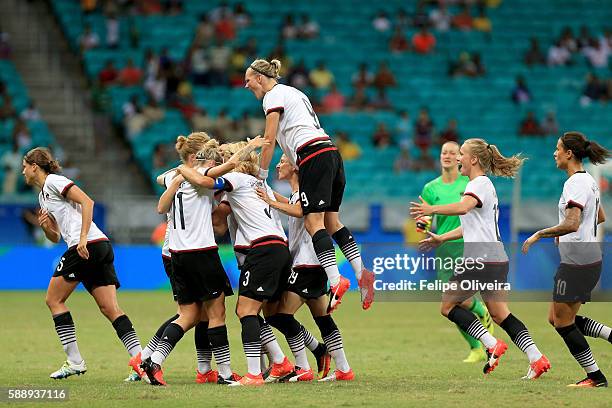 Melanie Behringer of Germany celebrates with team mates after scoring the opening goal during the Women's Football Quarterfinal match between China...