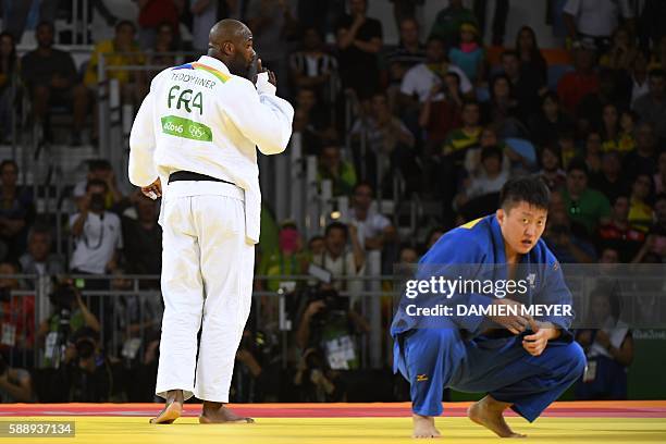 France's Teddy Rinerasks the audience not to celebrate before the final call during his fight against Japan's Hisayoshi Harasawa during the men's...