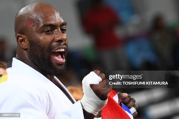 France's Teddy Riner celebrates after defeating Japan's Hisayoshi Harasawa during their men's +100kg judo contest gold medal match of the Rio 2016...