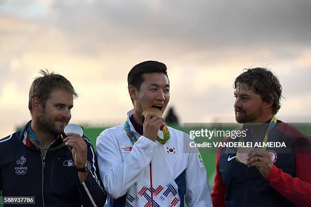 South Korea's gold medalist archer Ku Bonchan , France's silver medalist Jean Lacques Valladont and USA's Bronze medalist Brady Ellison pose on the...