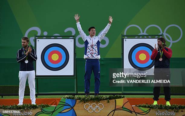 South Korea's gold medalist archer Ku Bonchan , France's silver medalist Jean Lacques Valladont and USA's Bronze medalist Brady Ellison pose on the...