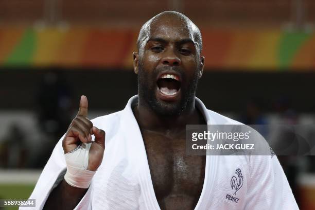 France's Teddy Riner celebrates after defeating Japan's Hisayoshi Harasawa during their men's +100kg judo contest gold medal match of the Rio 2016...