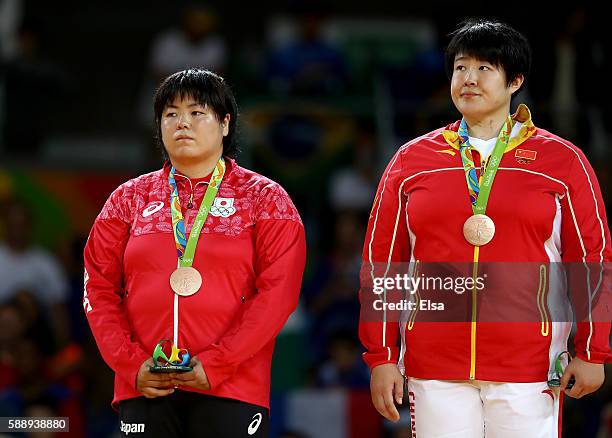 Bronze medalists Kanae Yamabe of Japan and Song Yu of China celebrates on the podium after the Women's +78kg Judo contest on Day 7 of the Rio 2016...