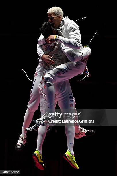 Miles Chamley-Watson of the United States celebrates with teammates after winning bronze in the Men's Foil Team event on Day 7 of the Rio 2016...