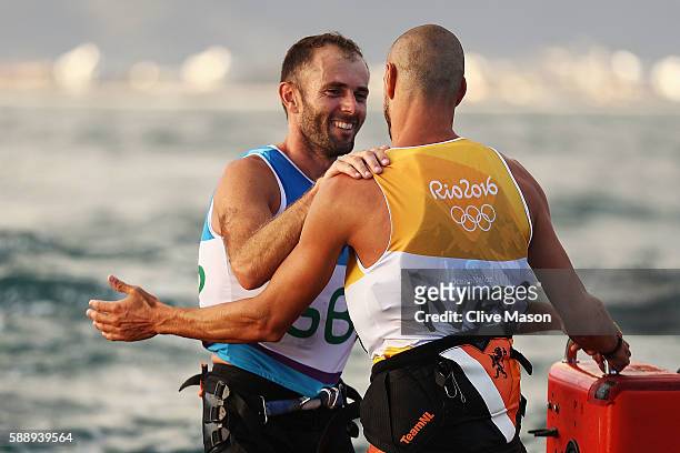 Dorian van Rijsselberghe of the Netherlands reacts after being assured of gold along with Nick Dempsey of Great Britain who is assured of silver in...