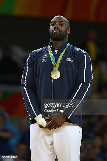 Teddy Riner of France celebrates on the podium after defeating Hisayoshi Harasawa of Japan during the Men's +100kg Judo Gold Medal contest on Day 7...