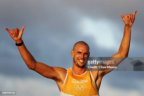 Dorian van Rijsselberghe of the Netherlands reacts after sealing gold in the Men's RS:X class on Day 7 of the Rio 2016 Olympic Games at Marina da...