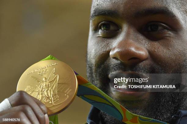 Gold medallist France's Teddy Riner celebrates on the podium of the men's +100kg judo contest of the Rio 2016 Olympic Games in Rio de Janeiro on...