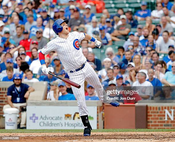 Chris Coghlan of the Chicago Cubs reacts after getting hit in the foot with a pitch during the seventh inning against the St. Louis Cardinals at...