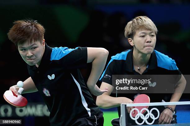 Huang Yi-Hua and Chen Szu-Yu of Chinese Taipei play a shot against Hong Kong during the Womens' Team Round 1 on Day 7 of the Rio 2016 Olympic Games...