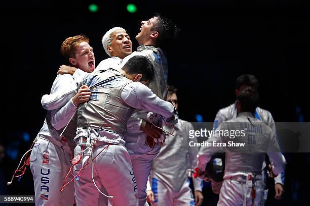 Race Imboden, Miles Chamley-Watson, Gerek Meinhardt and Alexander Massialas of the United States celebrate after winning bronze in the Men's Foil...