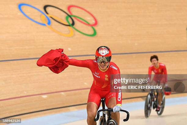 China's Zhong Tianshi and China's Gong Jinjie celebrate after winning gold in the women's Team Sprint finals track cycling event at the Velodrome...