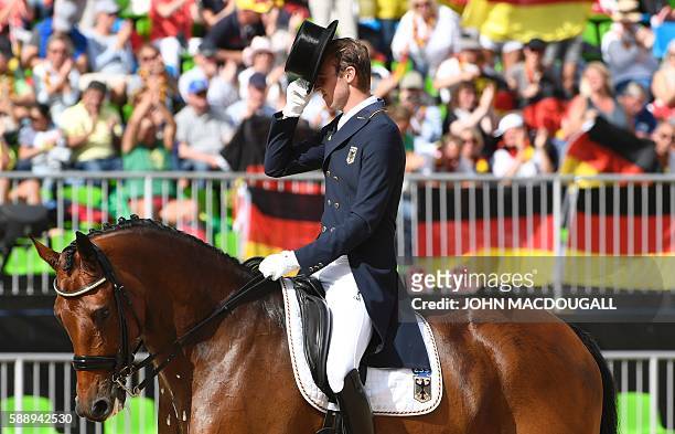 Germany's Sonke Rothenberg on Cosmo salutes the judge after performing his routine during the Equestrian's Dressage Grand Prix team final event of...